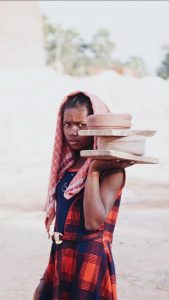 Girl Carrying Bricks